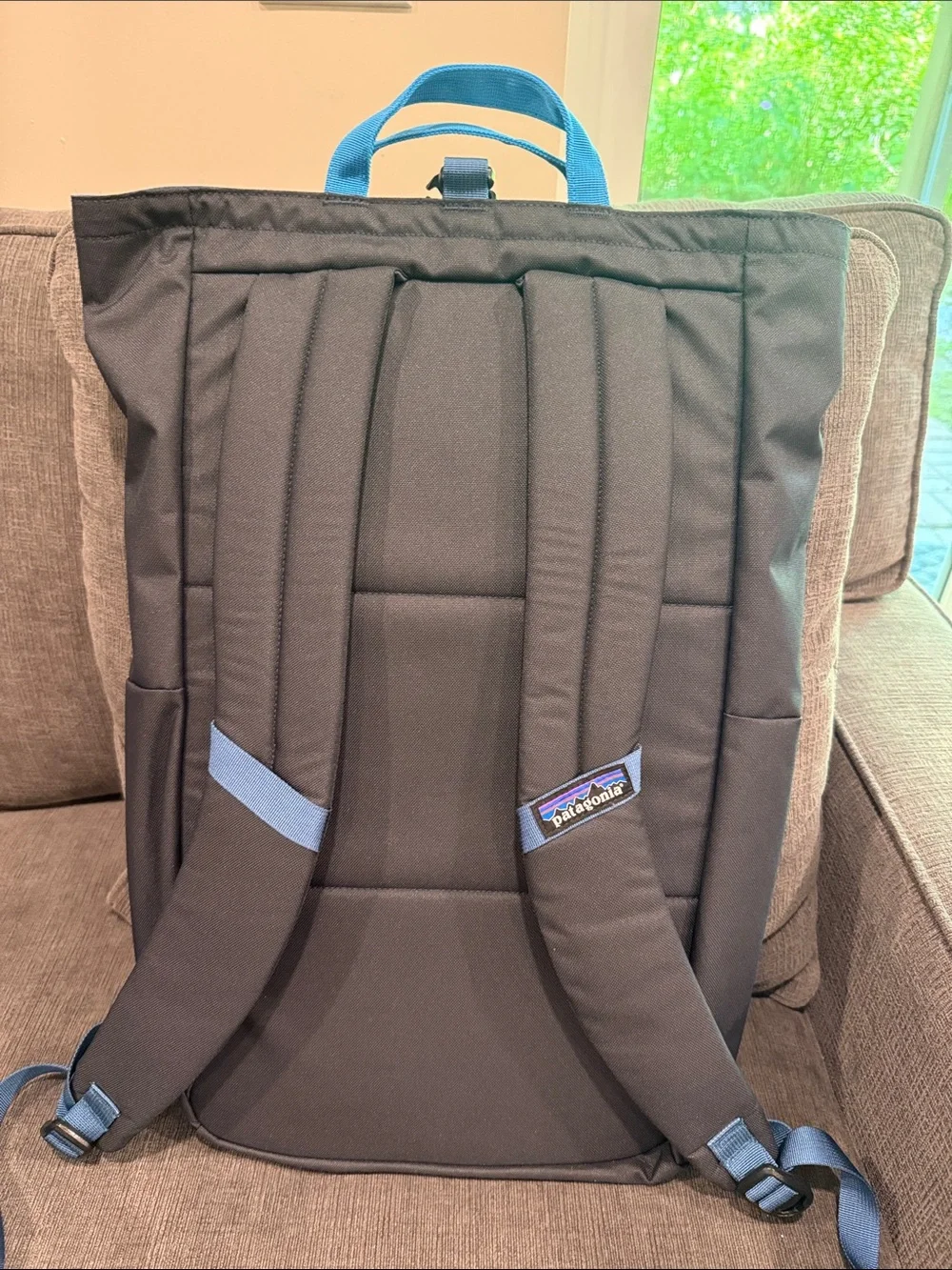 Patagonia Fieldsmith Black Roll-Top Backpack with Blue Handles and Pink Accents